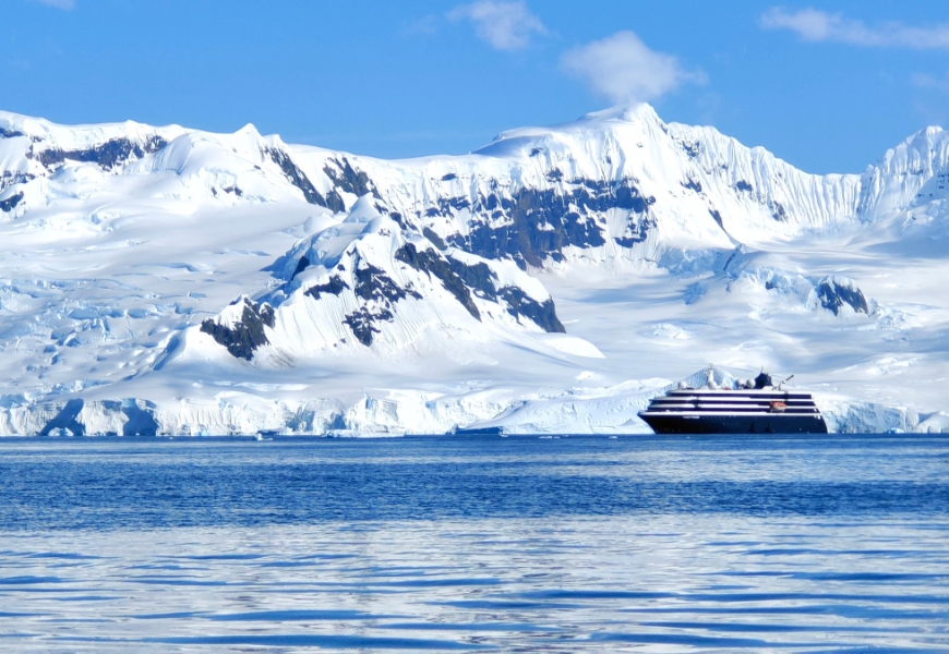 從海上角度拍攝遊輪，背景的冰山大陸隨處都是美景。