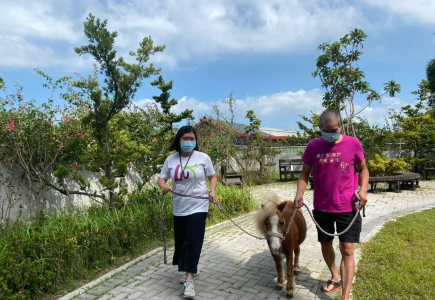 長輩帶著Blaze在園區內散步。