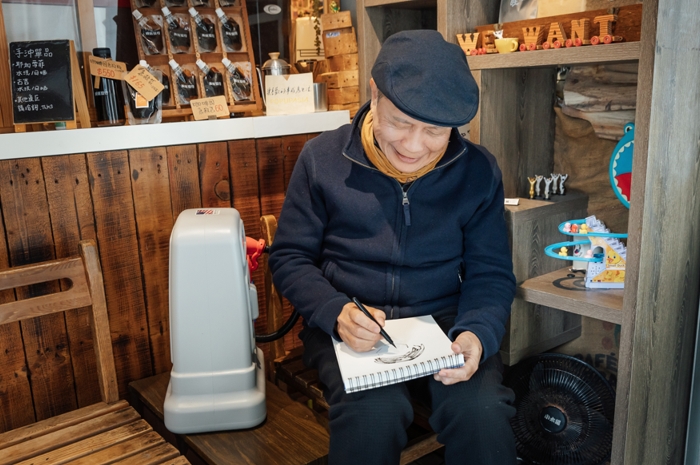 王正明在街邊咖啡店作畫，短短幾分鐘就勾勒出攝影師的神韻。