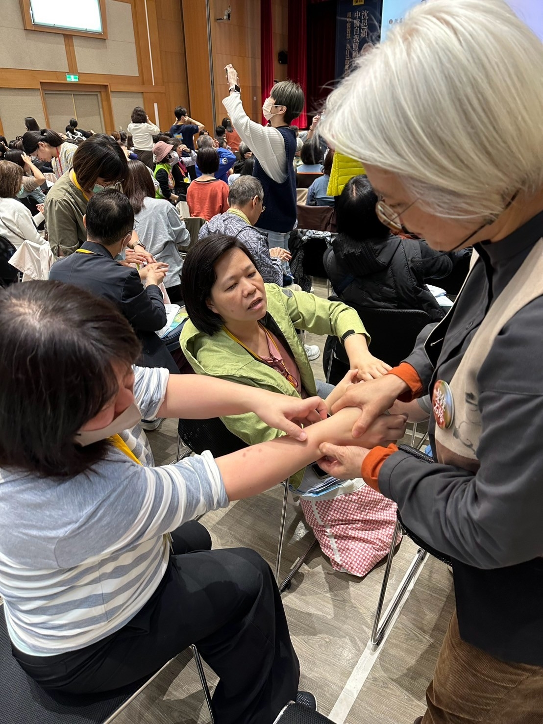 課程實作時間，沈邑穎親自指導《50+》學員按摩養老穴的方法。（《50+》提供）